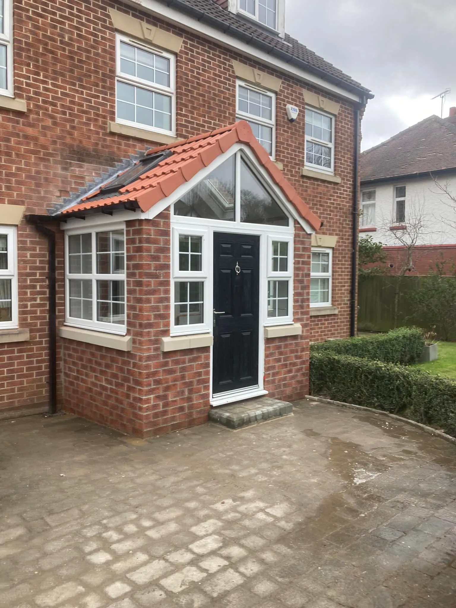 a brick house with a black door and windows