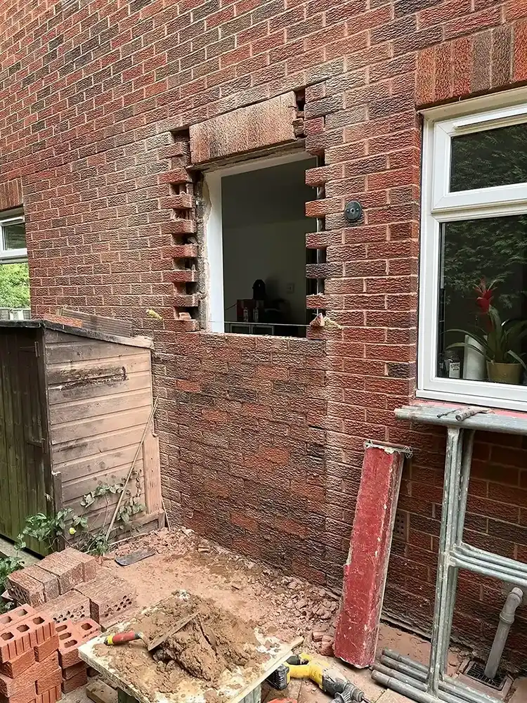 Doorway being bricked up.